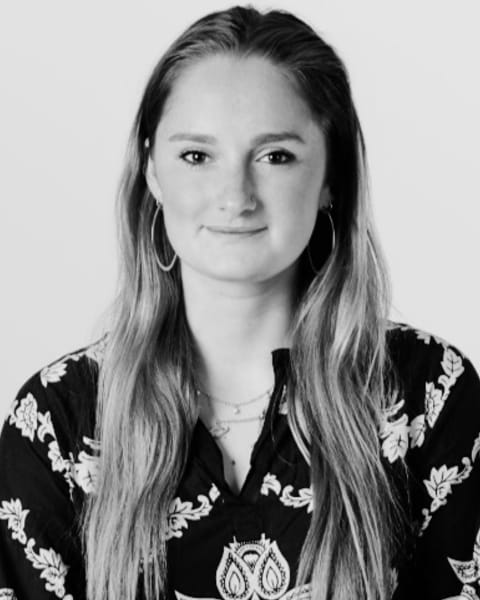 Freya Aylward, KST therapist, in a black and white portrait, with long hair and a patterned top